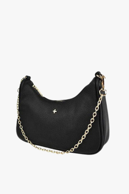 A small black vegan leather shoulder bag with a soft pebble texture, featuring a curved silhouette, gold-tone zip closure, and a short gold chain strap. The front of the bag is adorned with a subtle gold cross logo.