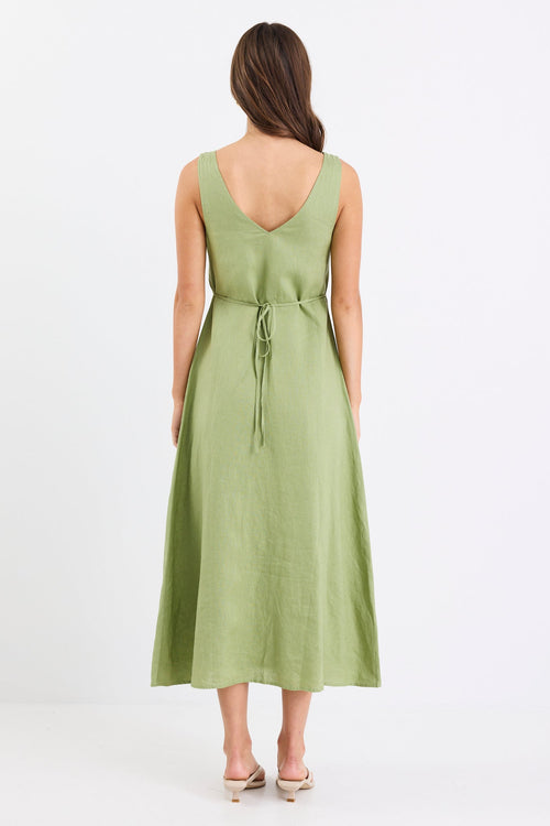 Woman wears a green button down front dress