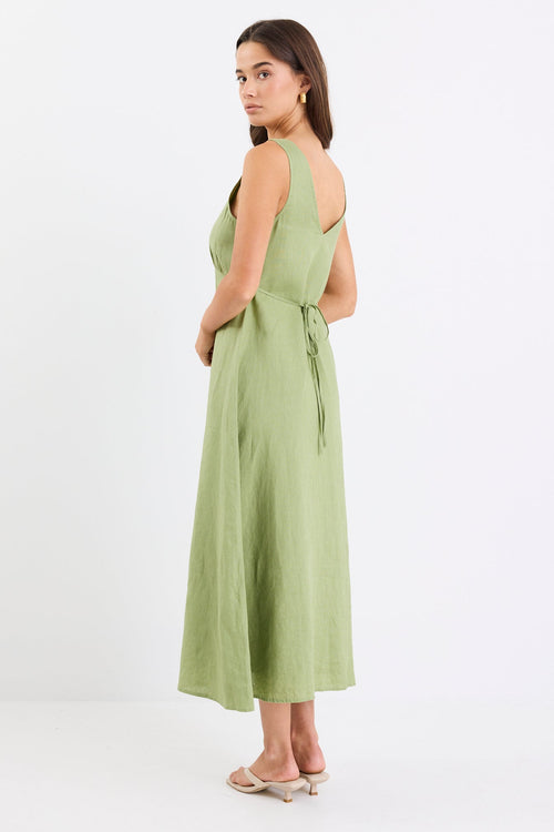 Woman wears a green button down front dress