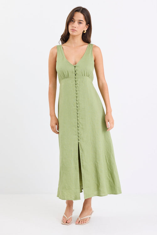Woman wears a green button down front dress