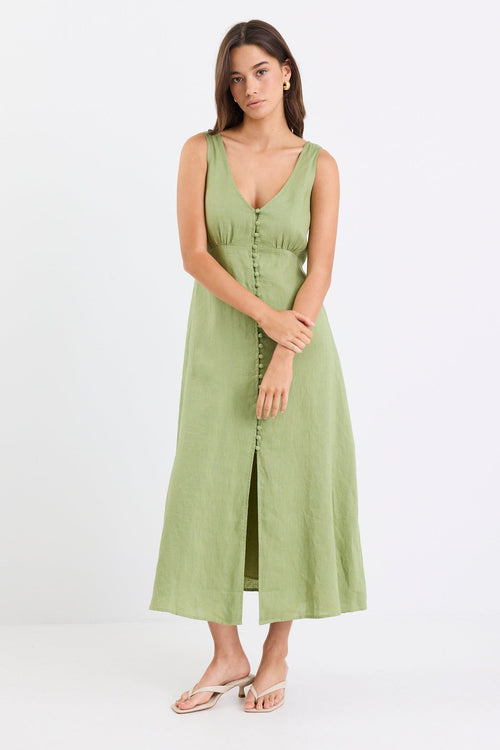 Woman wears a green button down front dress