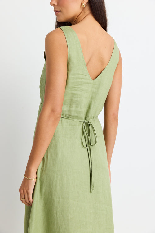 model wears a green linen midi dress