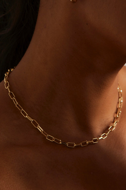model wearing paperclip gold necklace