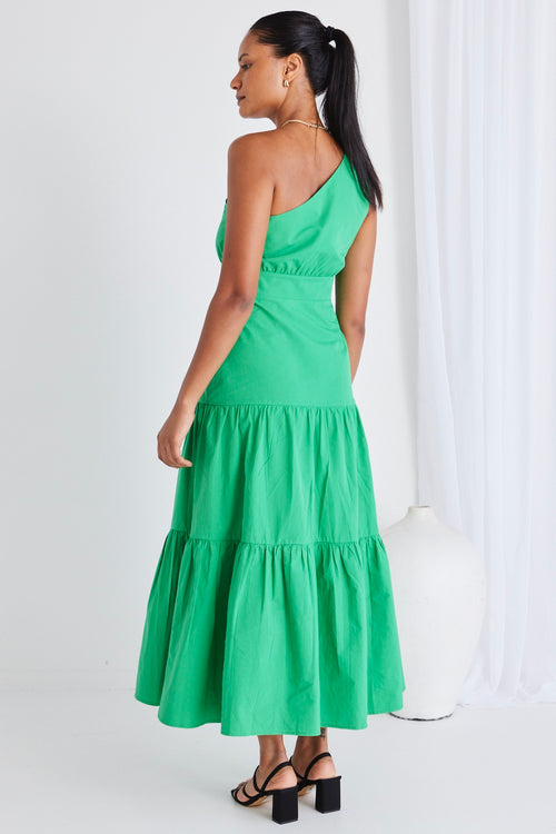 model wears long green maxi dress and black heels