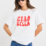The model wears a white t-shirt with red graphic text and blue jeans