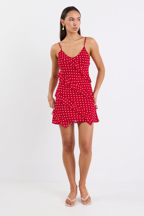 Woman wearing a mini red white polka dot ruffle dress