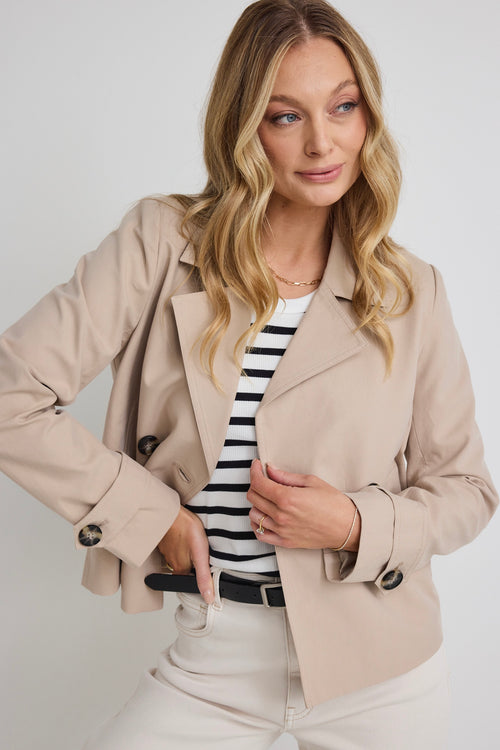 model wears a beige coat