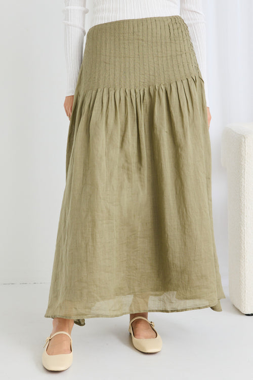 model wears a green linen skirt