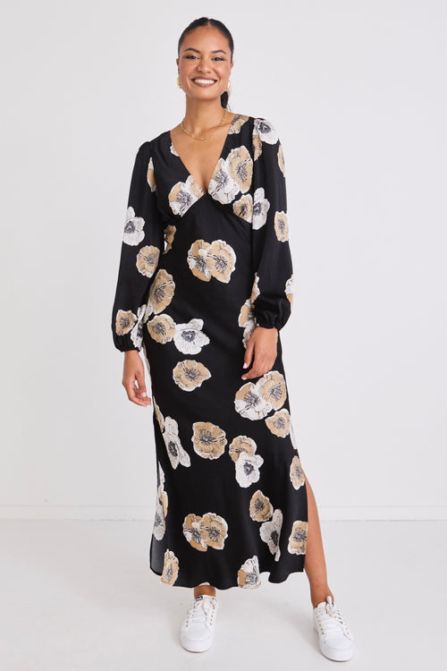 model wears a black floral maxi dress