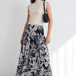 model wears a navy white floral maxi skirt