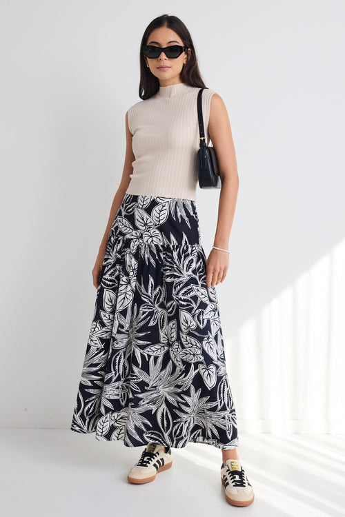 model wears a navy white floral maxi skirt