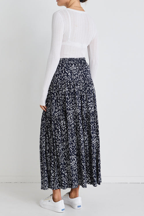 model wears a navy floral maxi skirt