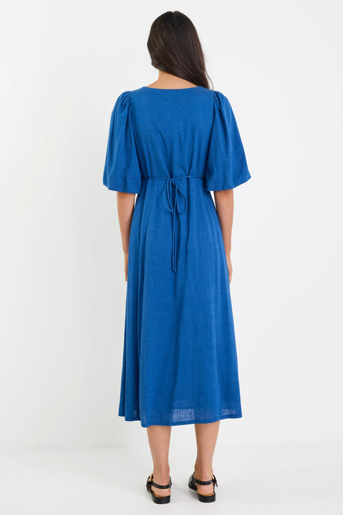 Woman wearing a blue dress on a white background