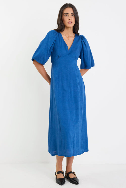 Woman wearing a blue dress on a white background