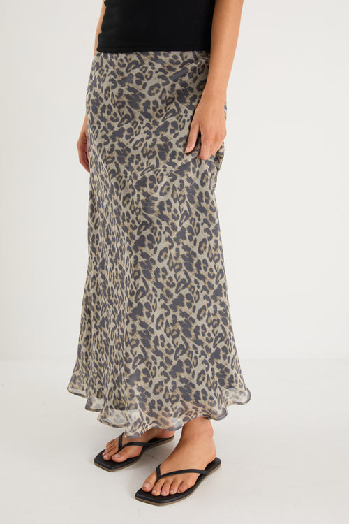 model wears a leopard maxi skirt with a black tank top