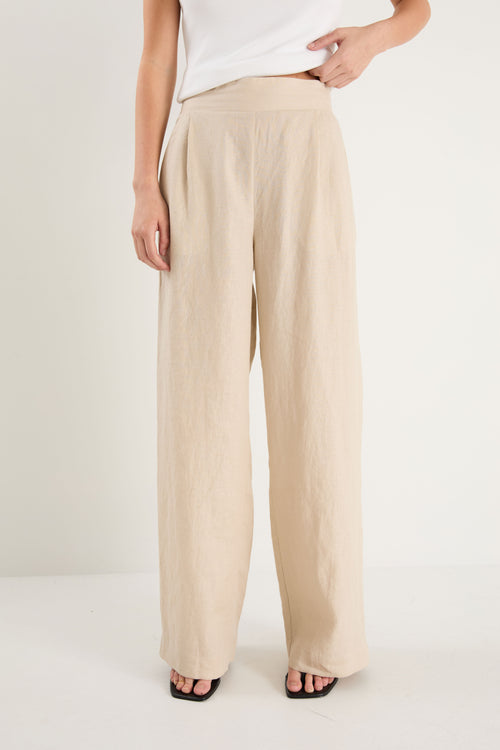Beige wide-leg pants worn by a person on a white background
