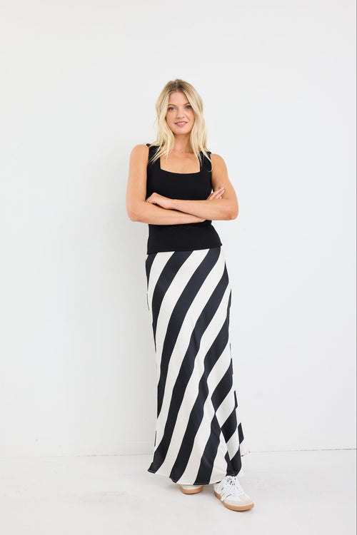 model wearing black white stripe satin maxi skirt