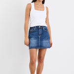 A mid-blue mini skirt with front pockets, made from a stretchy cotton blend. Features a classic denim wash, with 99% cotton and 1% elastane for a comfortable, breathable fit.