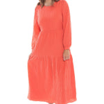 model posing in long sleeve orange maxi dress and white sneakers