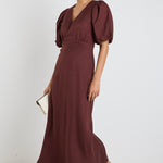model wears a brown linen puff sleeve maxi dress