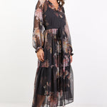 Black dress with floral print, balloon sleeves and tiered skirt.