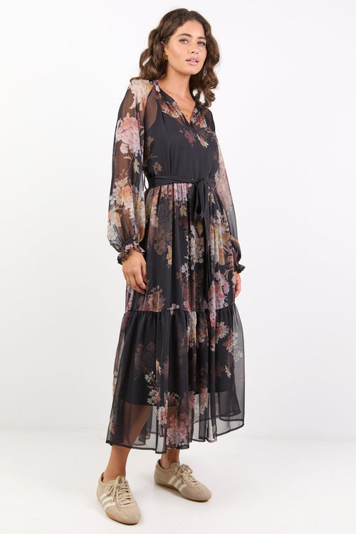 Black dress with floral print, balloon sleeves and tiered skirt.