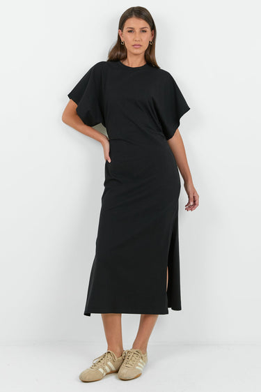 Woman wearing a black dress with a white background