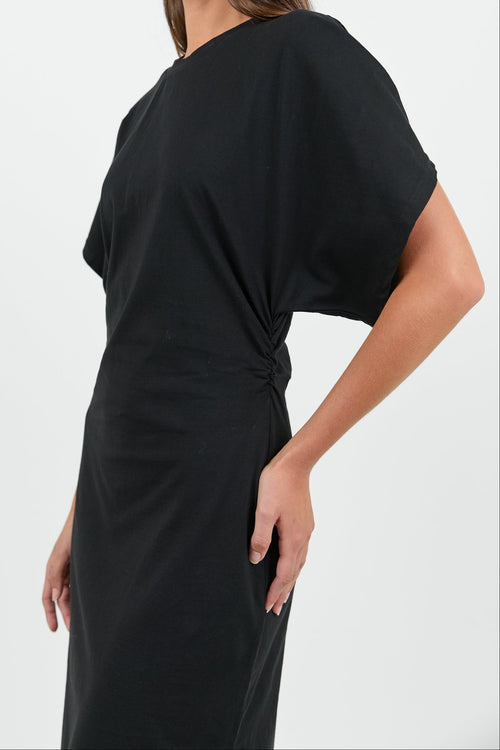 Woman wearing a black dress against a white background