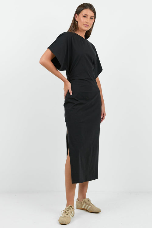 Woman wearing a black dress with a white background