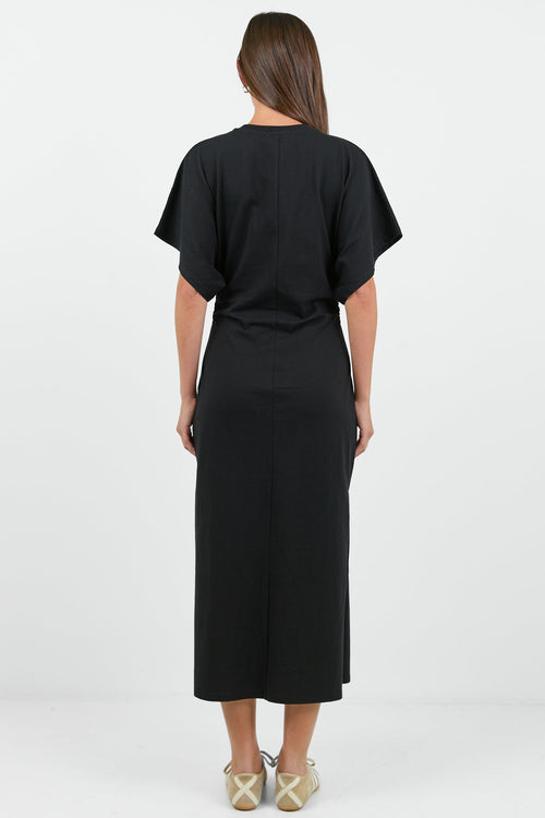Woman wearing a black dress with a white background