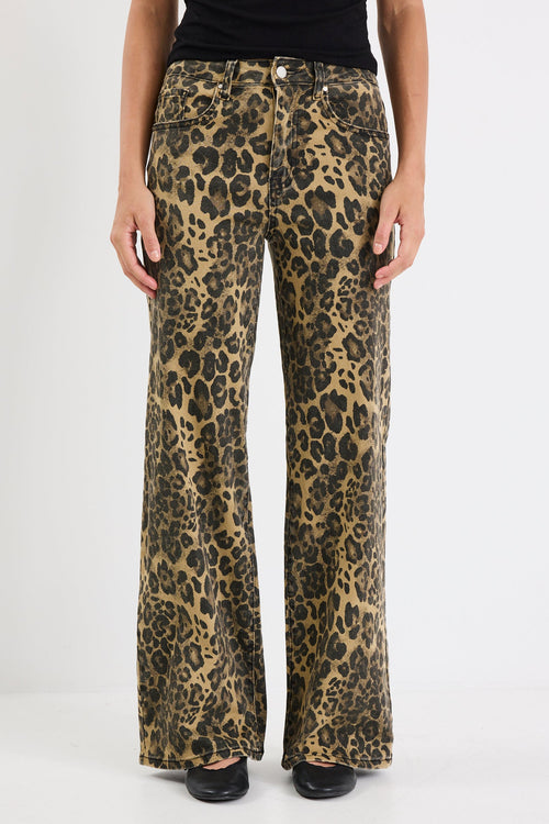 Leopard print pants worn by a person on a white background