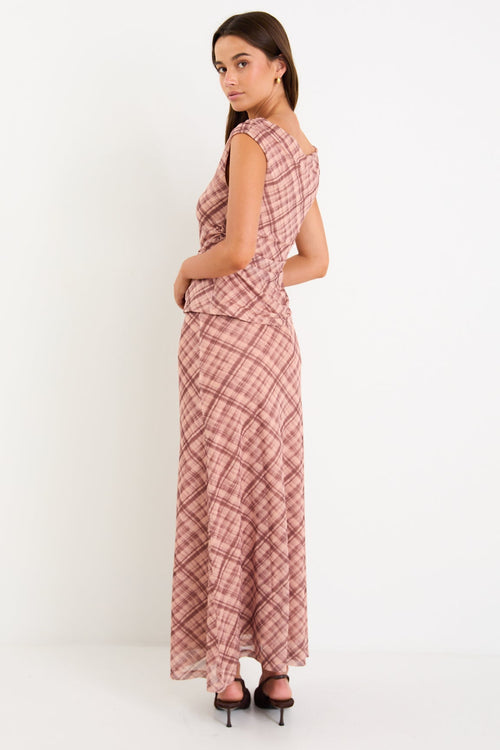Model wearing a blush check mesh panelled maxi skirt with a soft elastic waist and floaty silhouette