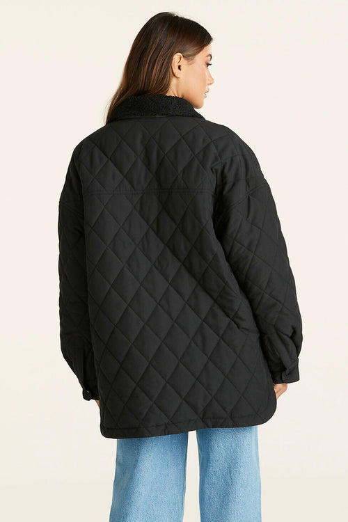 model wears a Black Quilted Jacket