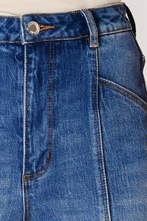 Close-up of blue denim jeans with a button and zipper on a white background