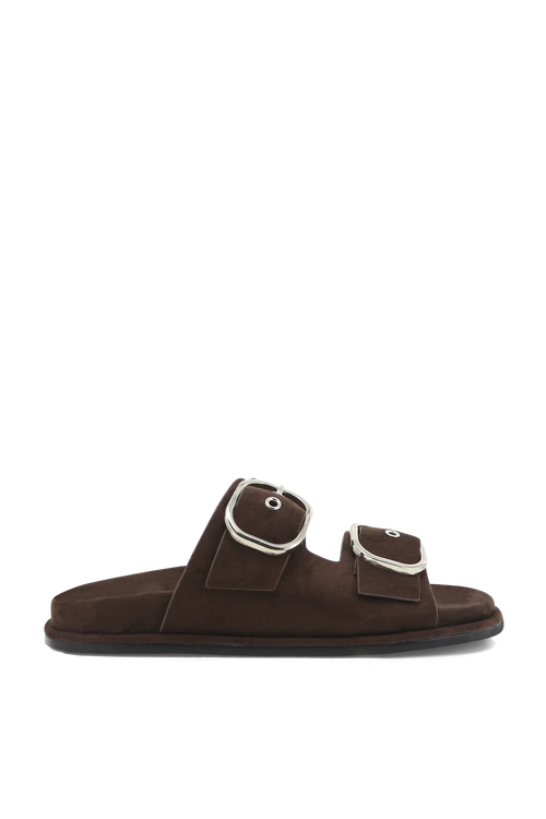A single dark brown suede slide sandal with two adjustable straps and large silver-tone metal buckles, shown in profile against a plain white background.