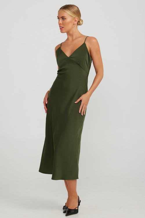 model wears a green slip midi dress