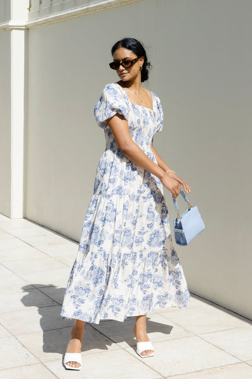 model wears a blue floral maxi dress