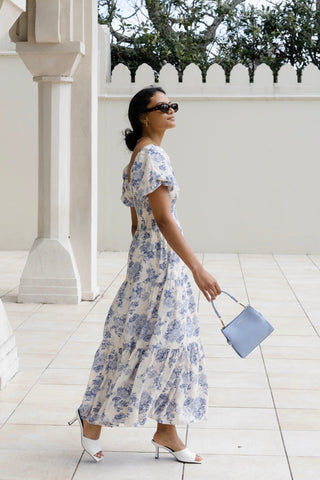 model wears a blue floral maxi dress