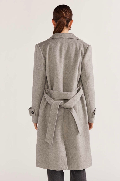 model wears a grey coat