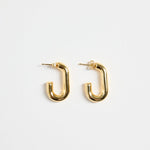 gold-plated brass huggie earrings with a sleek rectangular shape, photographed flat on a white background.