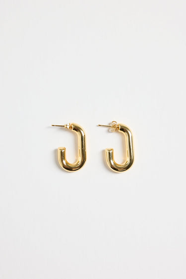 gold-plated brass huggie earrings with a sleek rectangular shape, photographed flat on a white background.