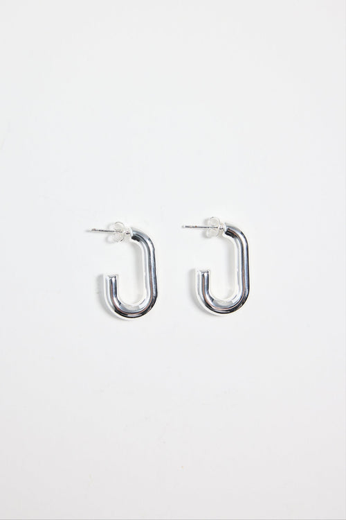 silver-plated brass huggie earrings with a rectangular shape, photographed flat on a white background.