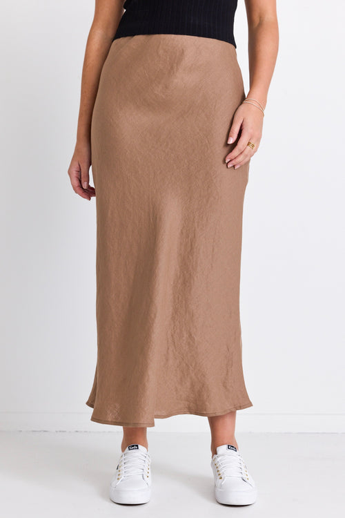 model wears a brown linen bias skirt