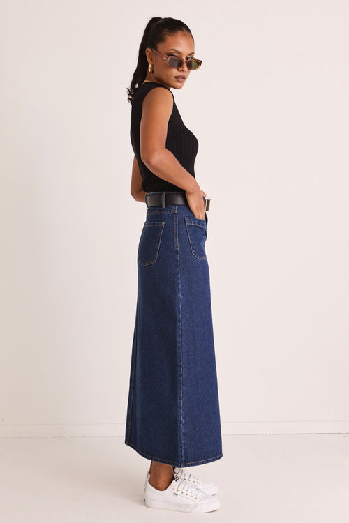 model wears a blue denim maxi skirt