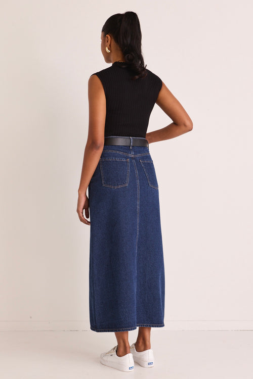 model wears a blue denim maxi skirt