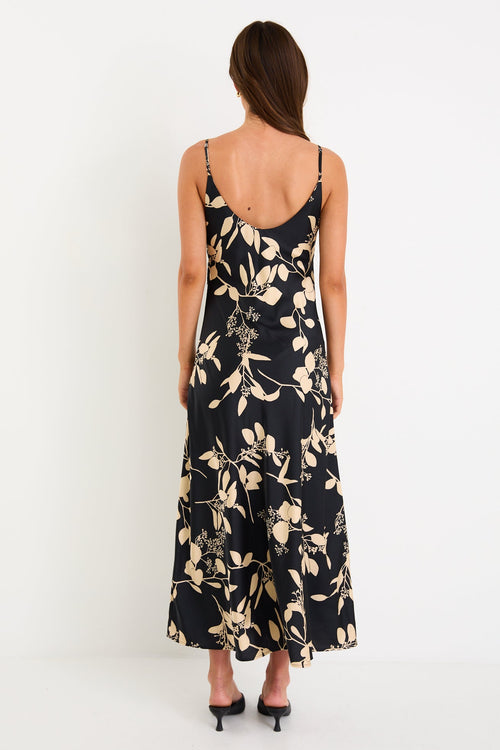 Woman wearing a black floral dress on a white background