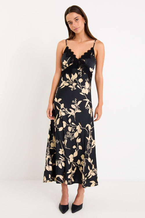 Woman wearing a black floral dress on a white background