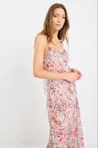 Woman wearing a strappy maxi dress in soft georgette with a floral and animal print blend, bias cut design, and flowing silhouette.