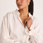 model wears a white stripe blouse