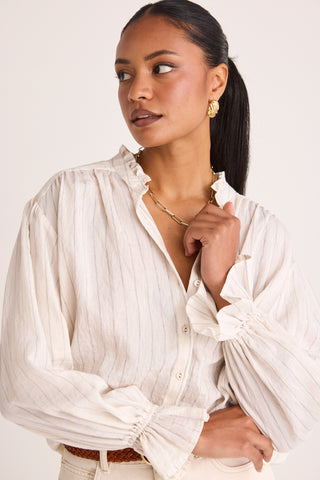 model wears a white stripe blouse